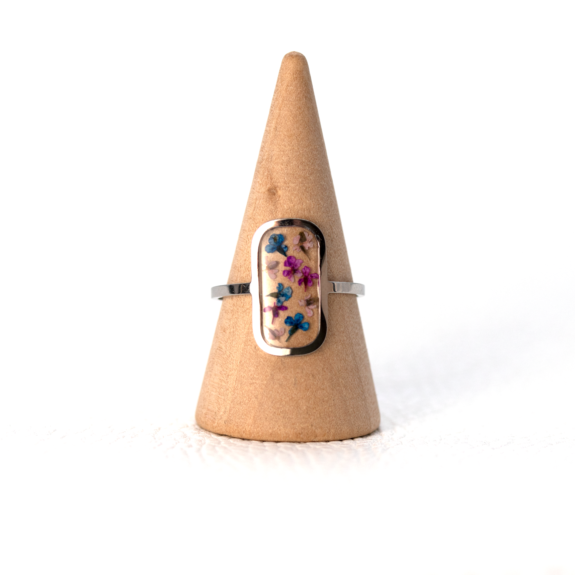 Tiny colorful flowers in silver rounded rectangle frame ring 2.png