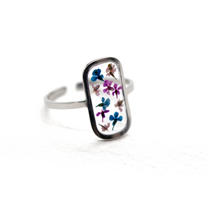 Tiny colorful flowers in silver rounded rectangle frame ring 3.png