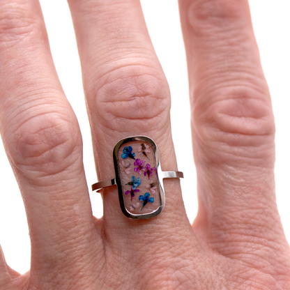 Tiny colorful flowers in silver rounded rectangle frame ring 4.png